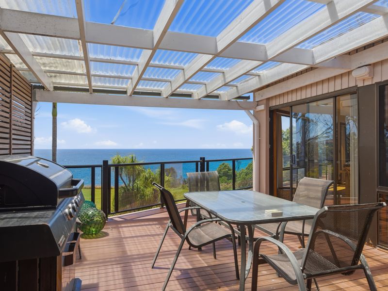 Covered outdoor dining with ocean glimpses