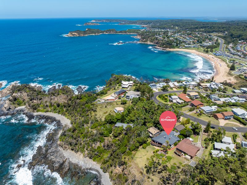Aerial view showcasing the home’s stunning coastal location
