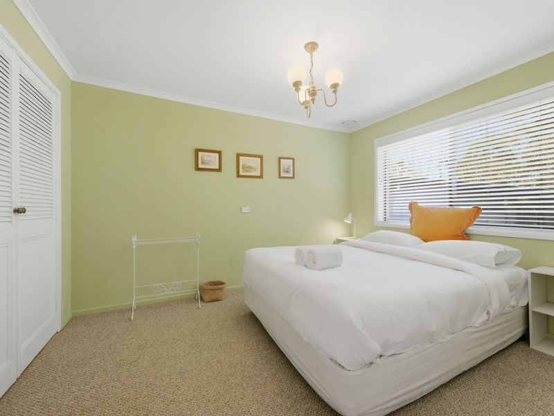 Spacious bedroom with large windows and natural light