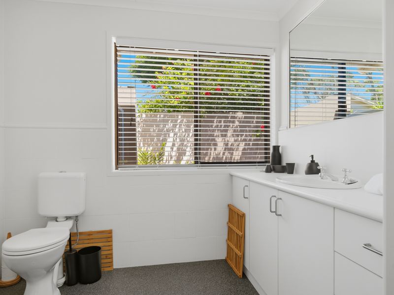 Bright bathroom with modern vanity and storage