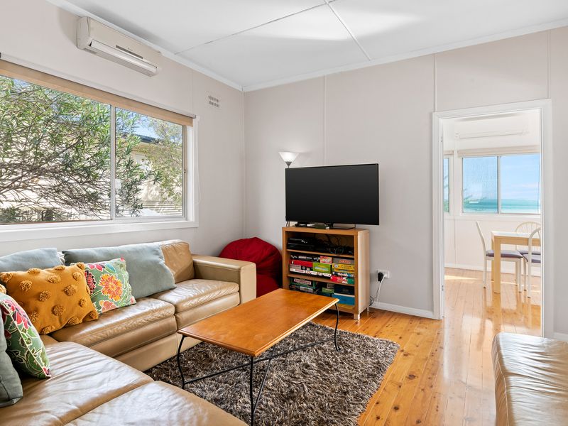 Spacious lounge with smart TV and warm timber floors