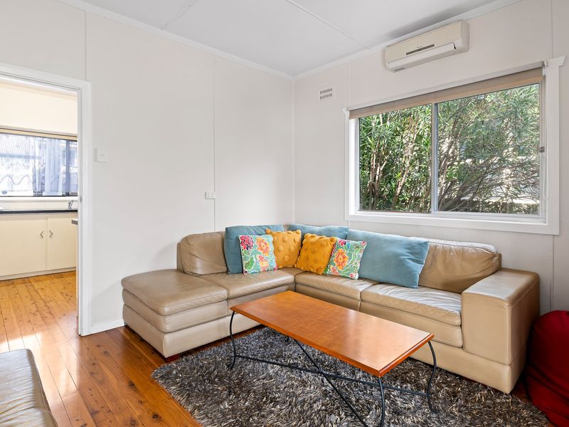 Comfortable living area with plush sofa and natural light