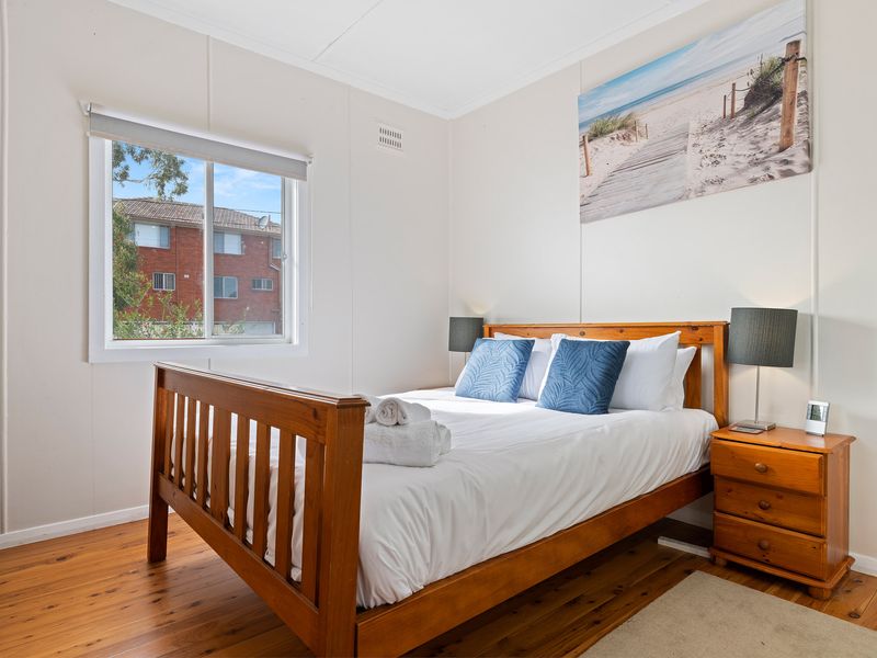 Queen bedroom with crisp linens and peaceful outlook