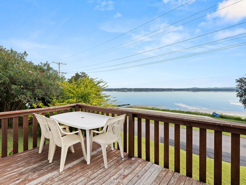 Deck with outdoor seating overlooking the water