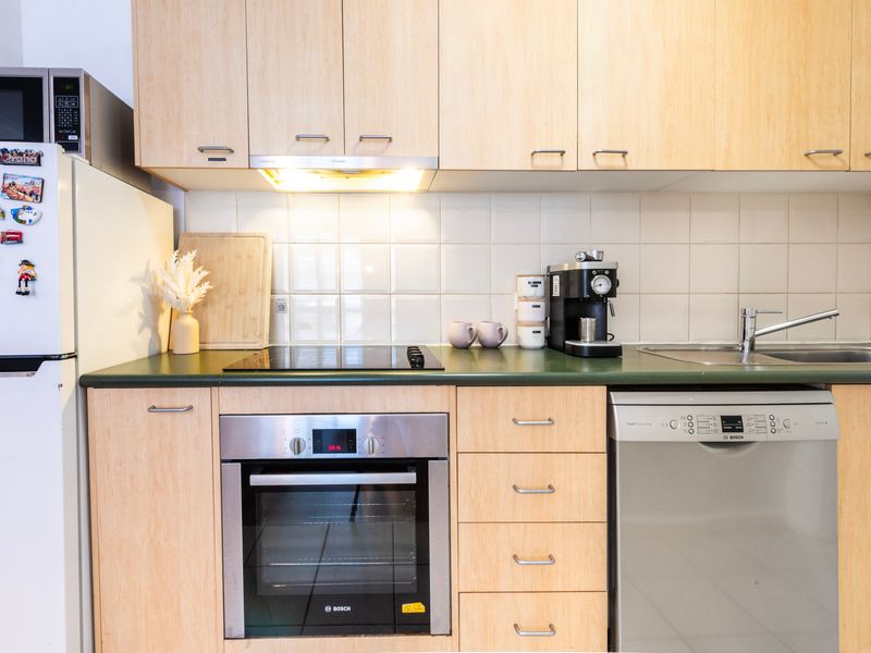 Clean, functional kitchen with ample storage and bench space