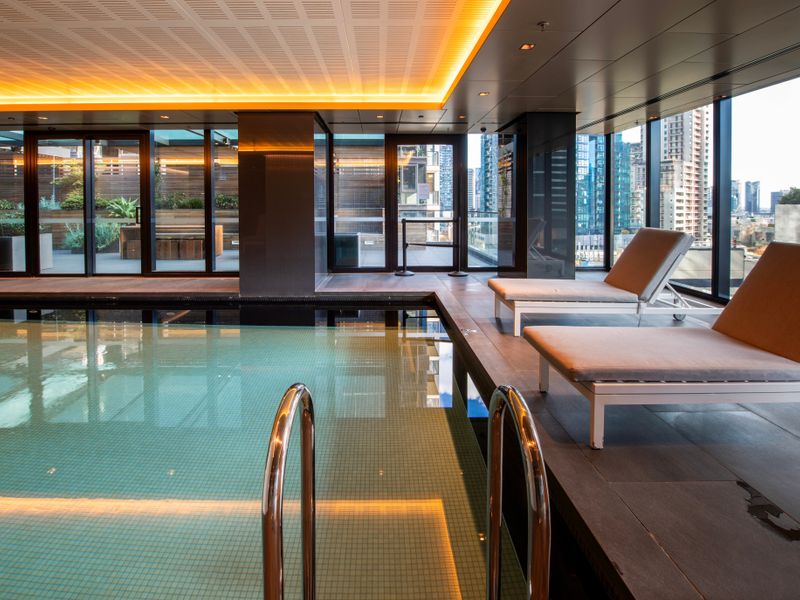 Resort-style pool area with comfortable lounging spaces to unwind.