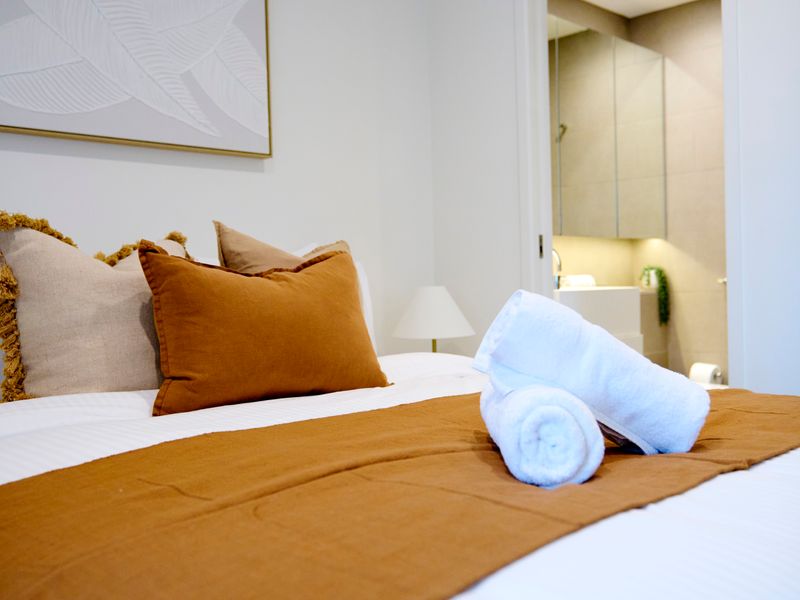 Freshly made bed with hotel-quality towels