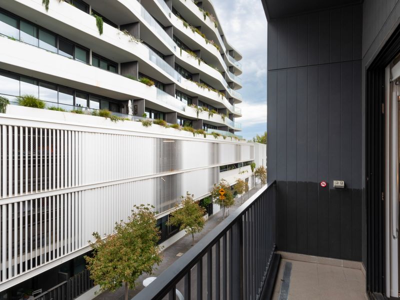 Private balcony retreat with outdoor seating and urban views.
