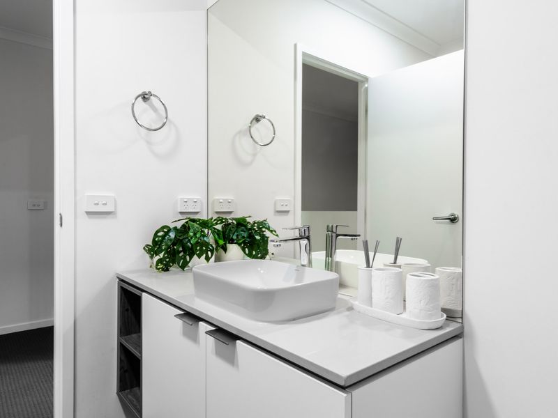 Stylish modern bathroom with stone tiles and elegant vanity.