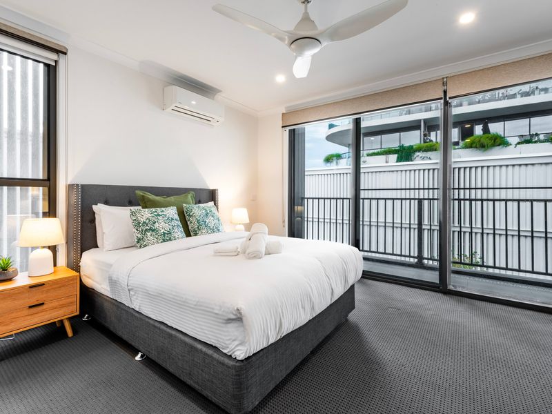 Master bedroom retreat with balcony access and natural light.