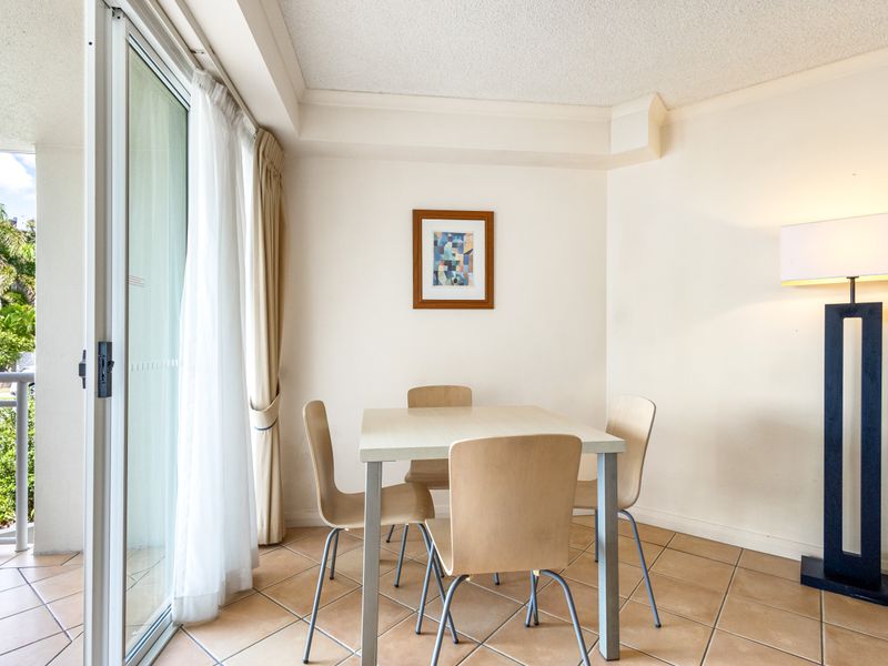 Dining table for four, and balcony access