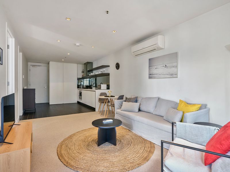 Spacious lounge with smart TV and cozy seating.