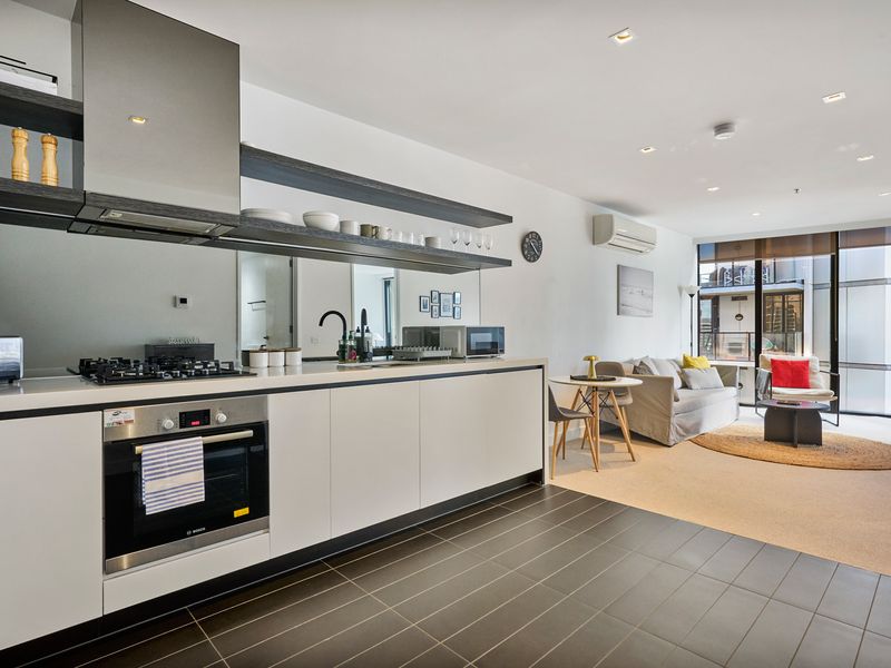 Sleek modern kitchen with stainless steel appliances and ample bench space.