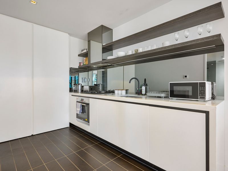 Fully equipped kitchen with oven, microwave, and generous storage.