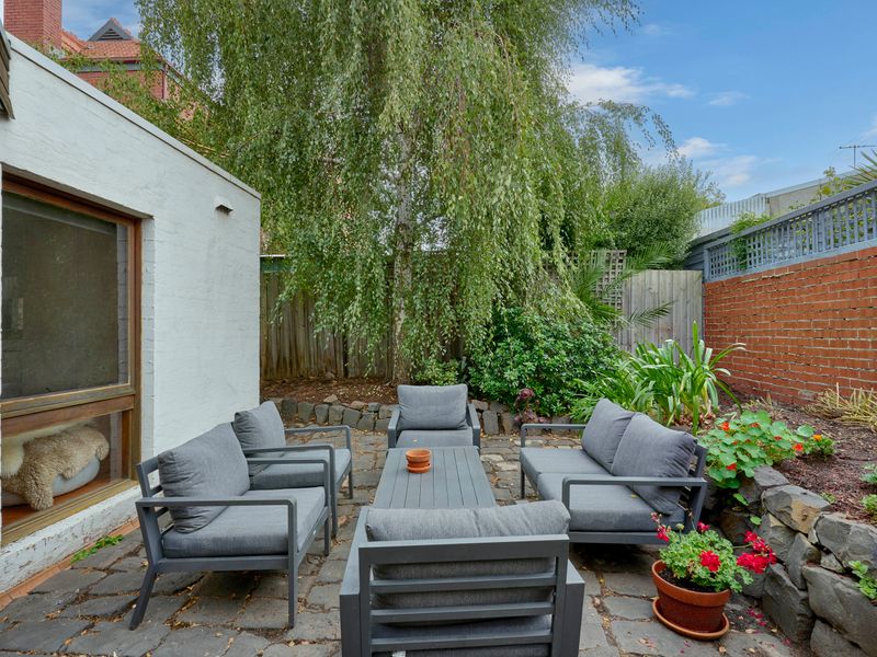 Sunny patio surrounded by greenery — perfect for morning coffee