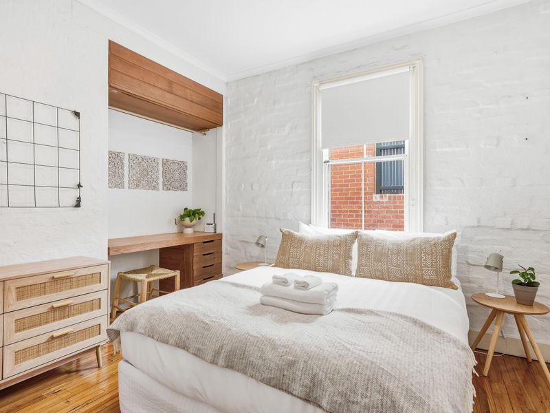 Inviting queen bedroom with soft neutrals and natural light