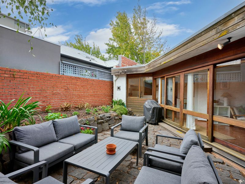 Private courtyard retreat with outdoor seating and BBQ area