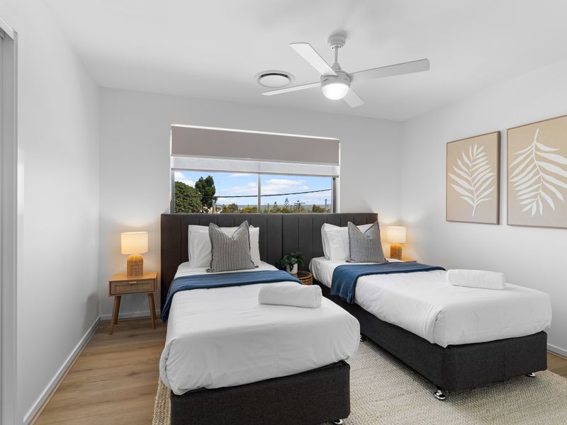 Stylish twin bedroom with comfortable beds and a relaxing coastal feel.