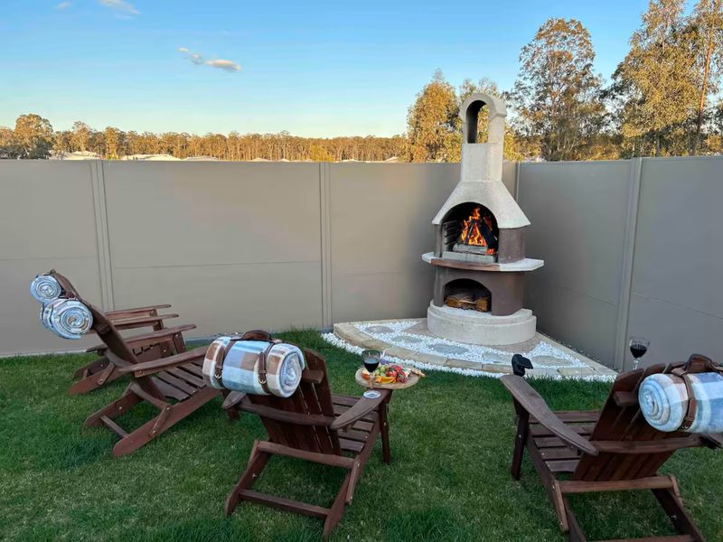Cozy outdoor fireplace with chairs—perfect for relaxing by the fire.