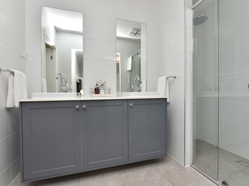 Stylish bathroom with double sinks and ample storage.