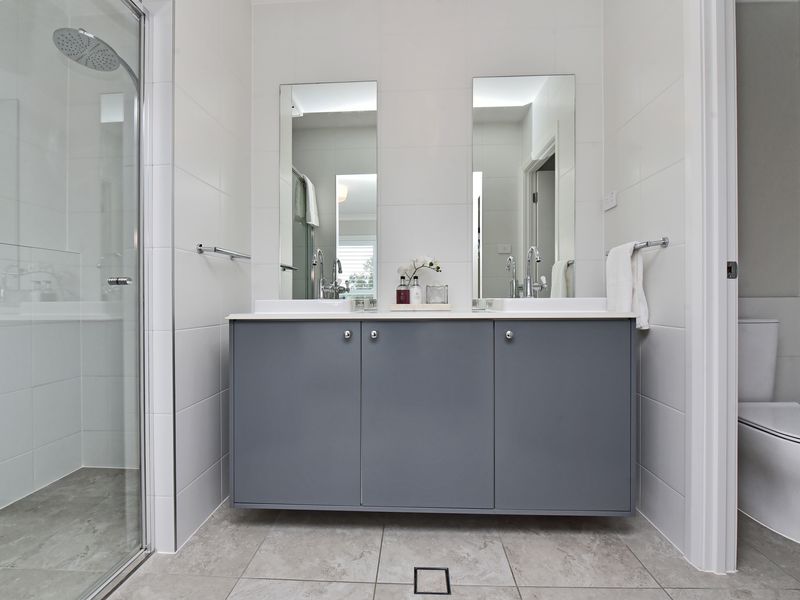 Bright, modern bathroom with twin mirrors.