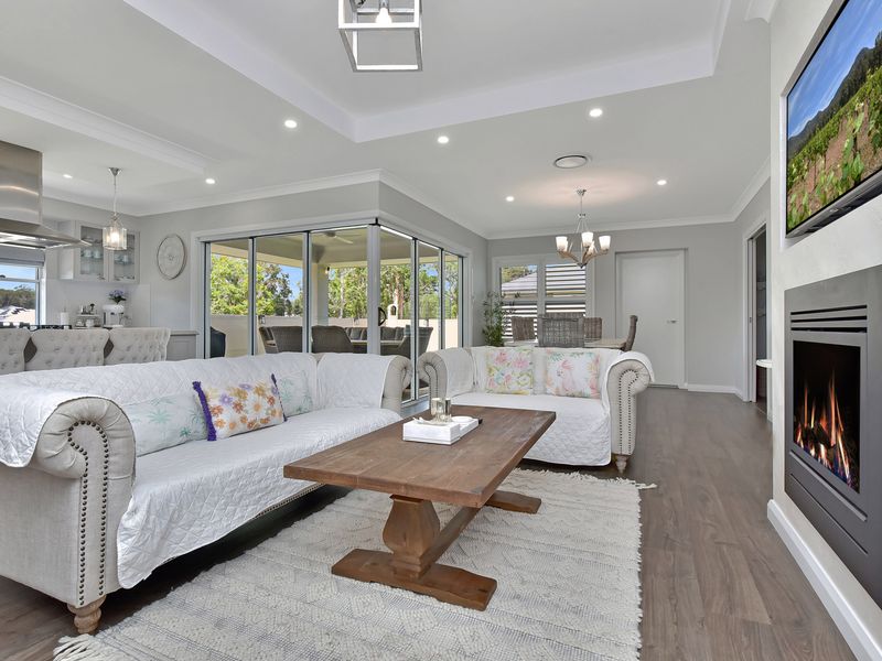 Bright white living room with cozy sofa and stylish centerpiece.