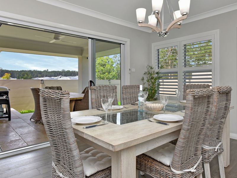 Elegant dining for six with beautiful indoor views through glass doors.