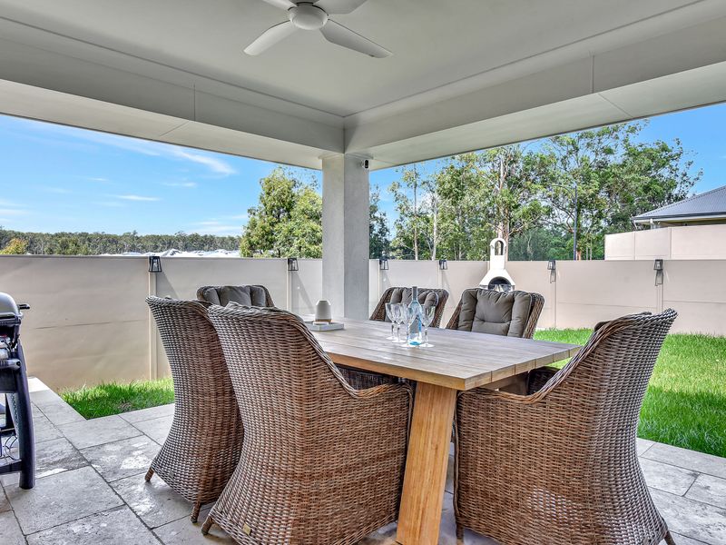 Alfresco dining with BBQ and a view of the lush lawn.