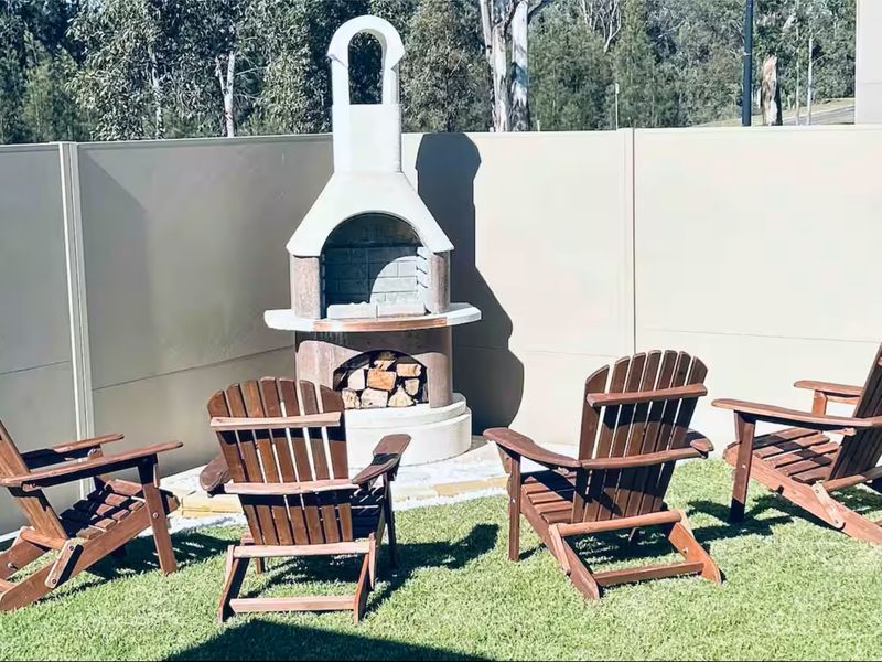 Inviting outdoor fireplace with chairs—great for unwinding.