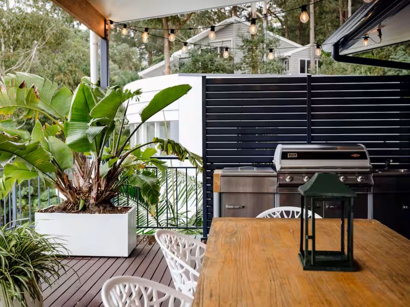 Private outdoor patio surrounded by tropical plants perfect for relaxing.