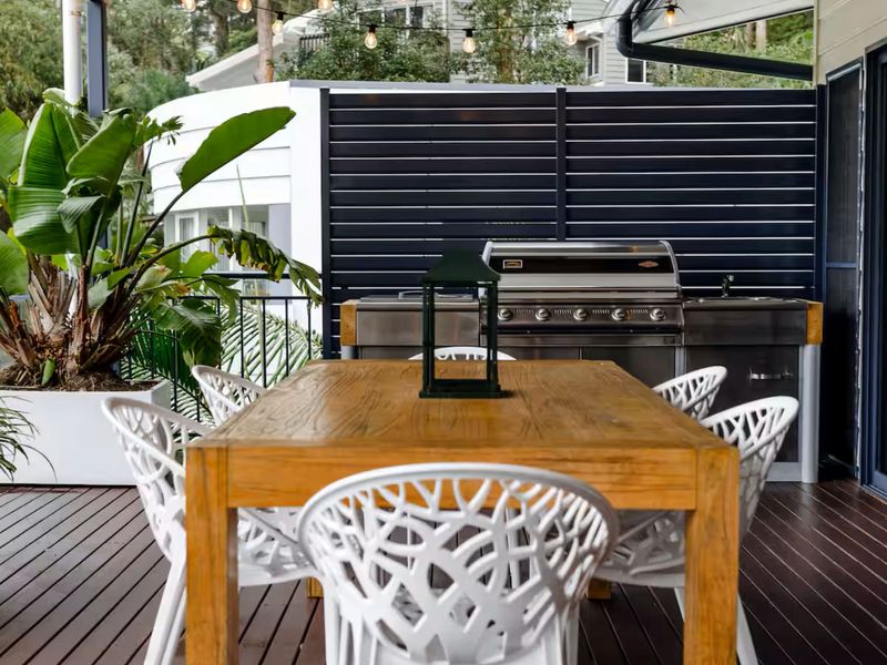 Outdoor dining area with BBQ ideal for meals and entertaining.