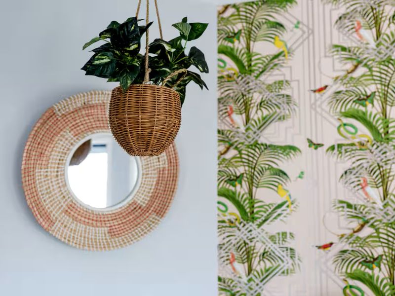 Beautiful woven mirror and greenery creating a welcoming and relaxed atmosphere.