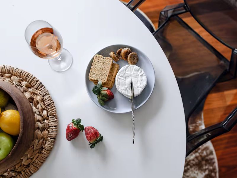 Enjoy a fresh morning with coffee, fruit, and a cozy breakfast setting.