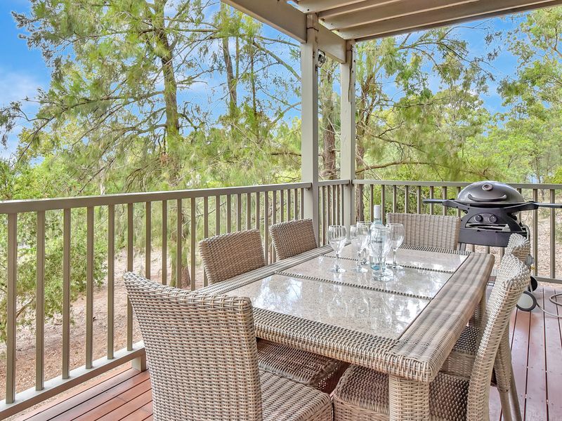 Covered balcony with outdoor dining and BBQ