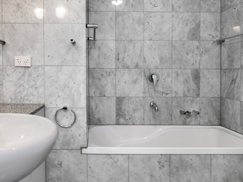 Ensuite bathroom with full size bathtub, ideal for unwinding after a long day