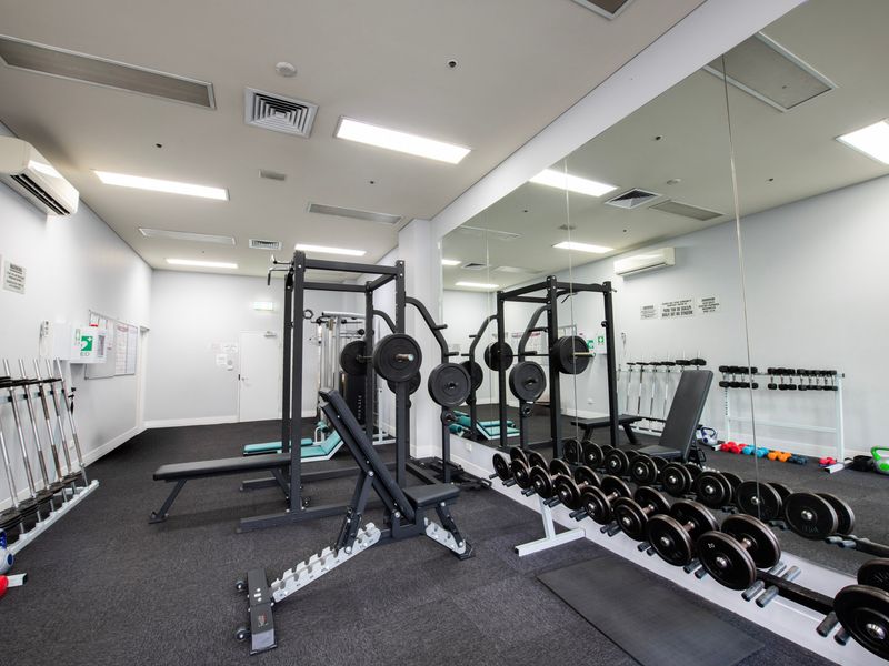 Spacious gym featuring free weights and functional training equipment