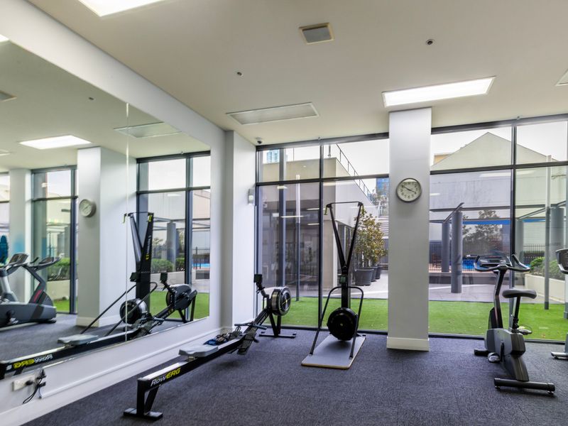 Fully equipped gym with natural light and a range of cardio and strength equipment
