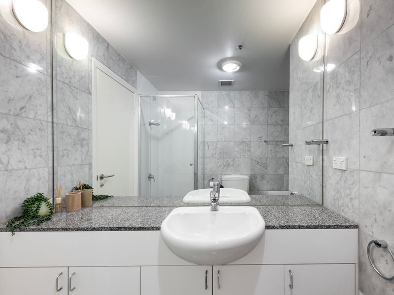 Spacious vanity with large mirror, offering plenty of storage and a bright, open feel