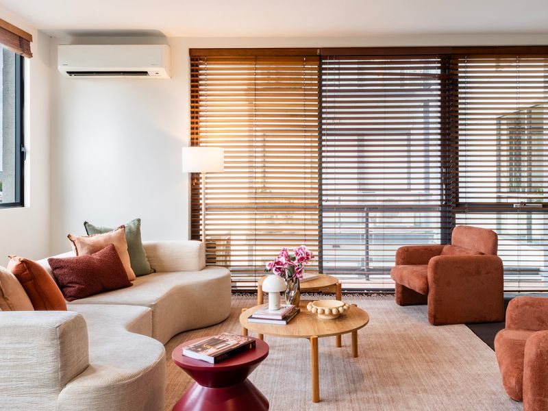 Sunlit living room with warm textures, soft furnishings and a relaxed, inviting atmosphere