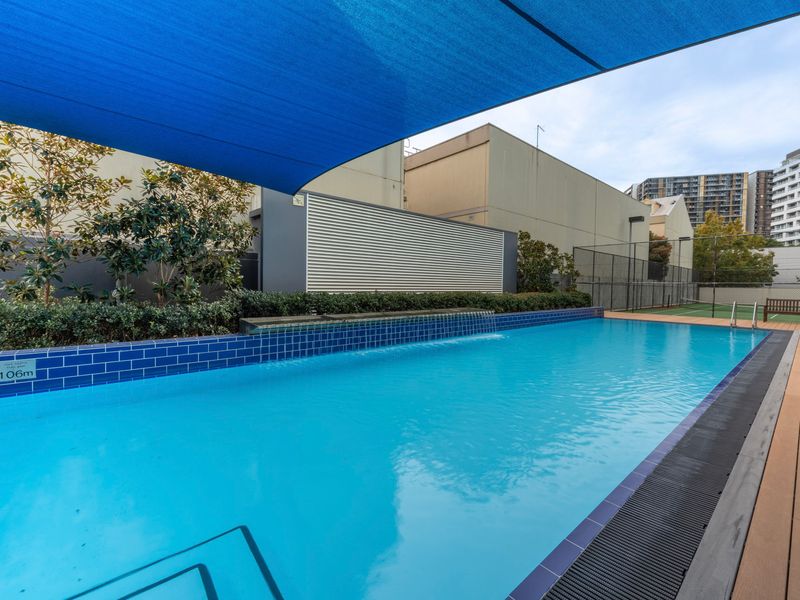 Outdoor pool with shaded area, perfect for relaxing or cooling off on warmer days