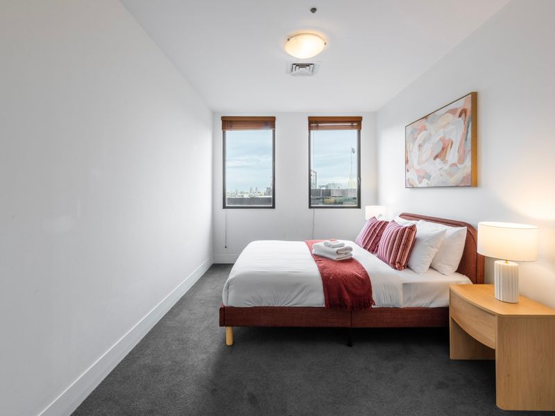 Light filled bedroom featuring a queen bed and a calm, restful atmosphere