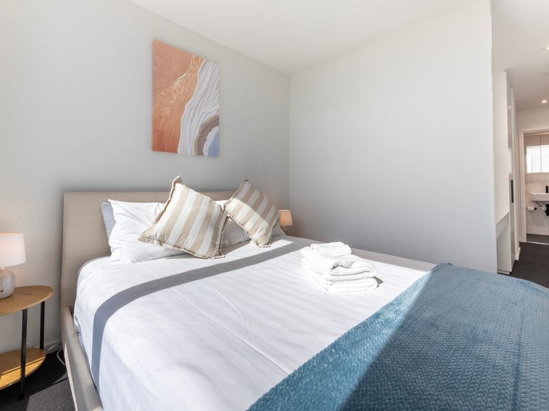 Spacious master bedroom with queen bed and quality linen