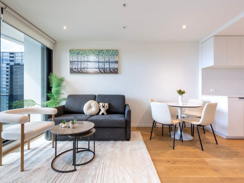 Relax in a bright, spacious living area with comfy seating and smart TV.