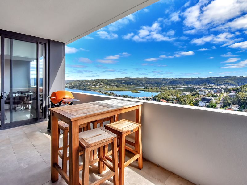 Private balcony with outdoor dining and sweeping water views.