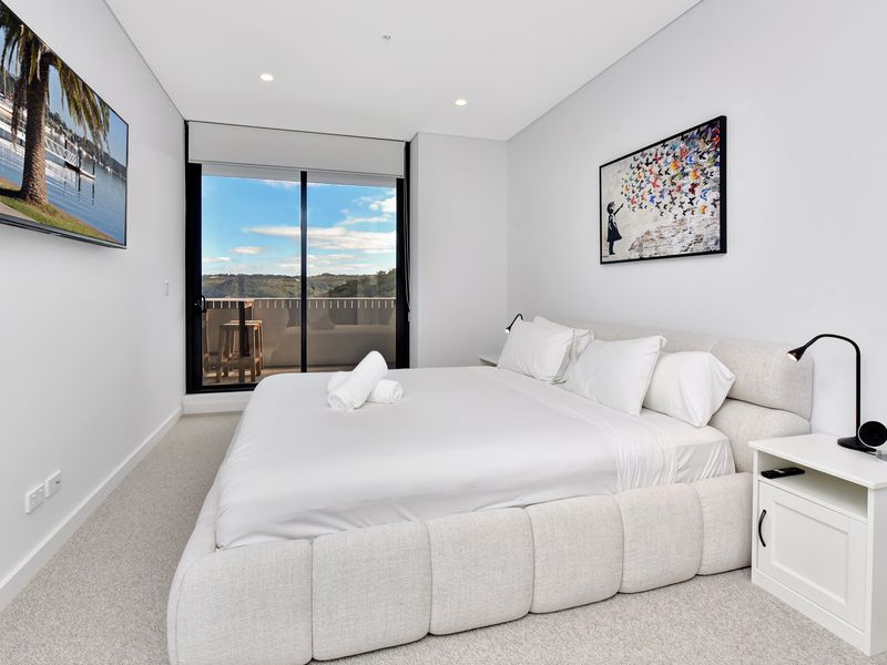 Peaceful queen bedroom with city and water views.