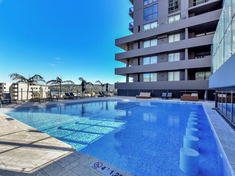 Resort-style infinity pool overlooking the city skyline.
