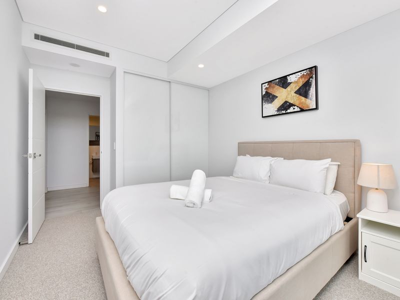 Bright second bedroom with quality linens.