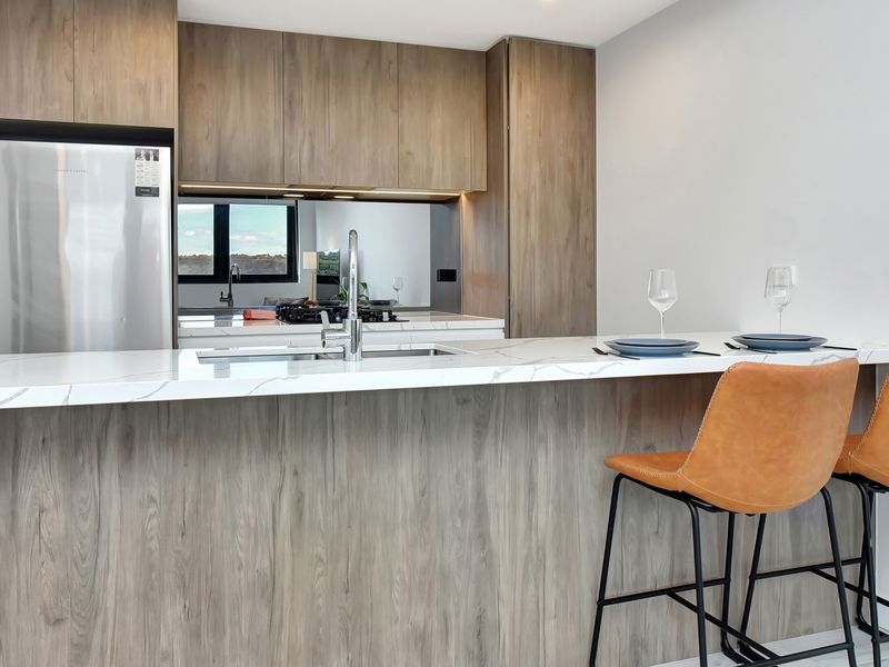 Contemporary kitchen with breakfast bar and quality appliances.