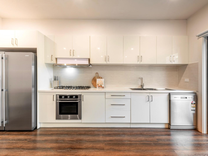 Fully equipped kitchen with stainless steel appliances and ample bench space for easy meal preparation.