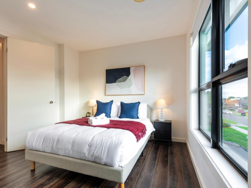 Another angle of the Queen bedroom showcasing the bright and airy layout.